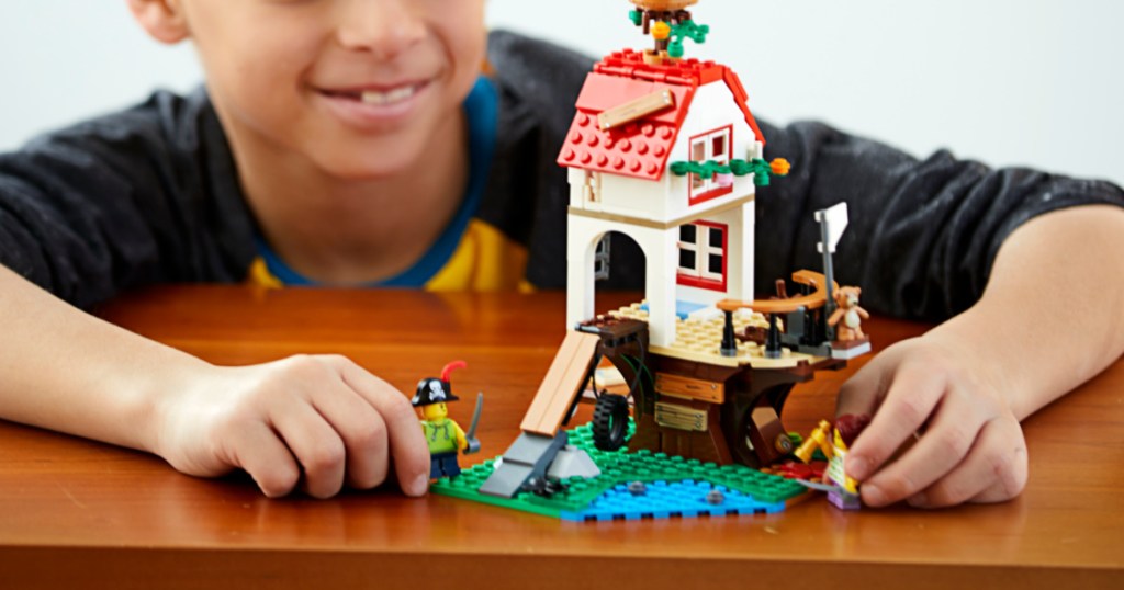 lego treehouse with little boy playing