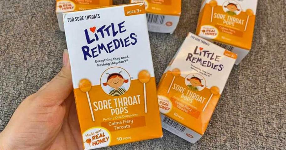 hand holding box of Little Remedies Sore Throat Pops