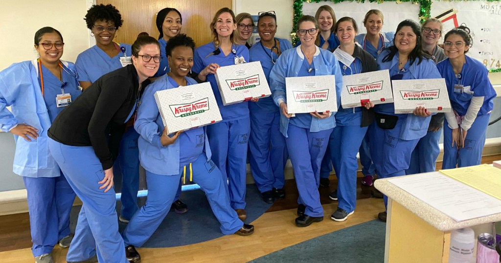 nurses holding krispy kreme boxes