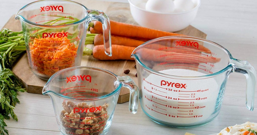 counter with measuring cups and vegetables on it