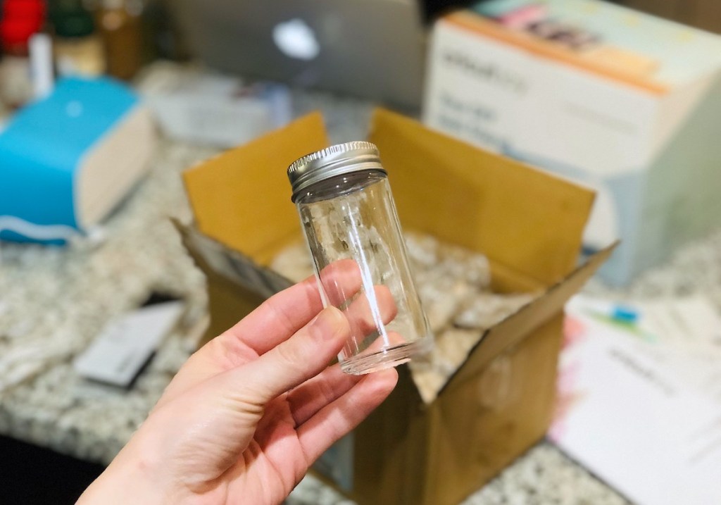 hand holding a clear spice jar