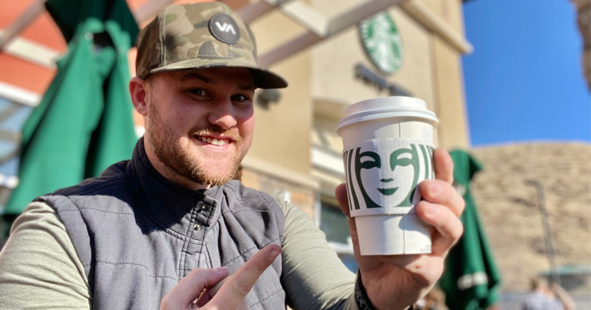 man holding hot starbucks drink outside - cheap starbucks drinks