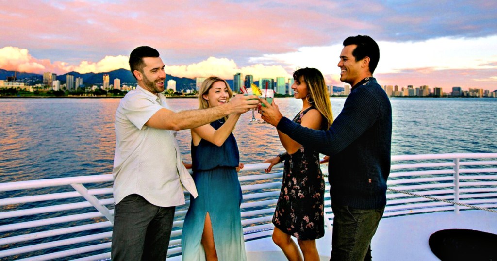 two couples toasting champagne on a boat