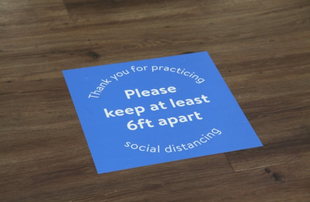 floor decal instructing shoppers to keep 6 feet apart 