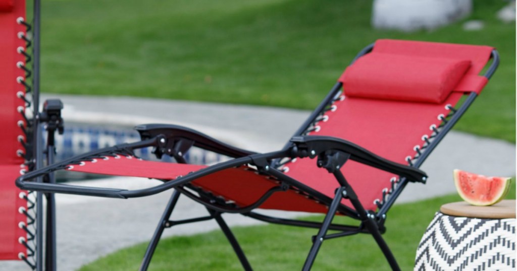 red chair reclined outside by pool