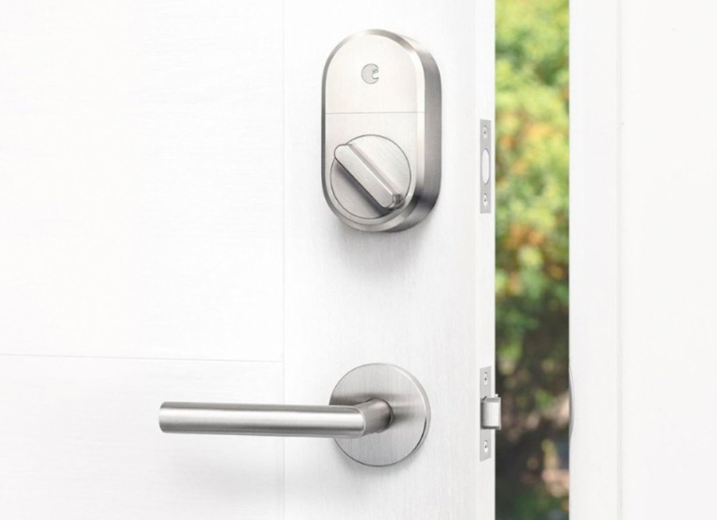 smart lock installed on deadbolt on inside of white door