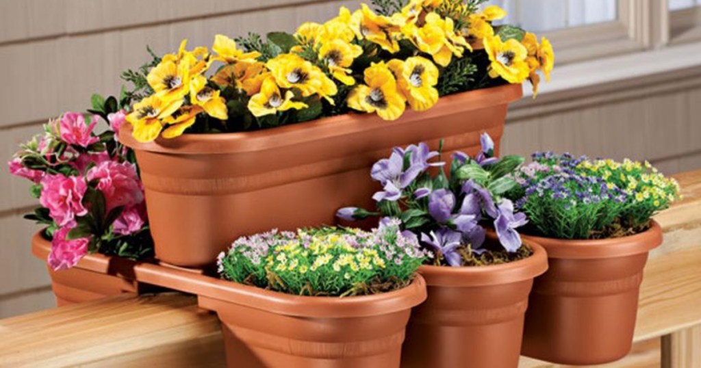 Bloem Terra Cotta Milano Plastic Deck Rail Planter 4-Pack with colorful flowers within the flower pots