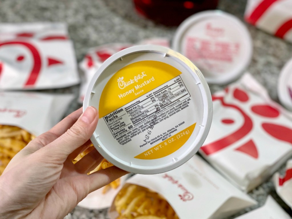 Woman holding Chick-fil-A Honey Mustard Sauce