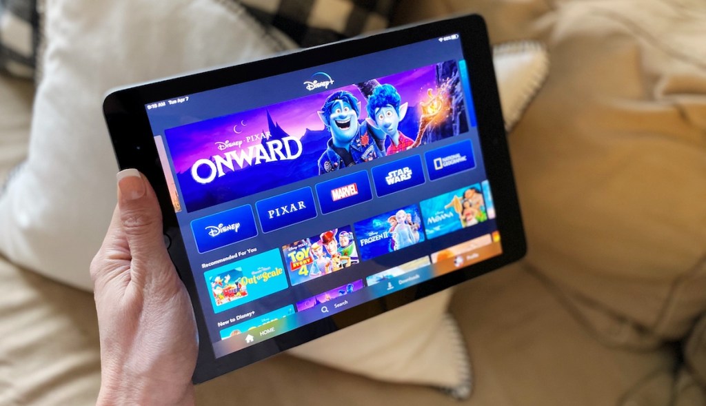 hand holding tablet with Disney movies