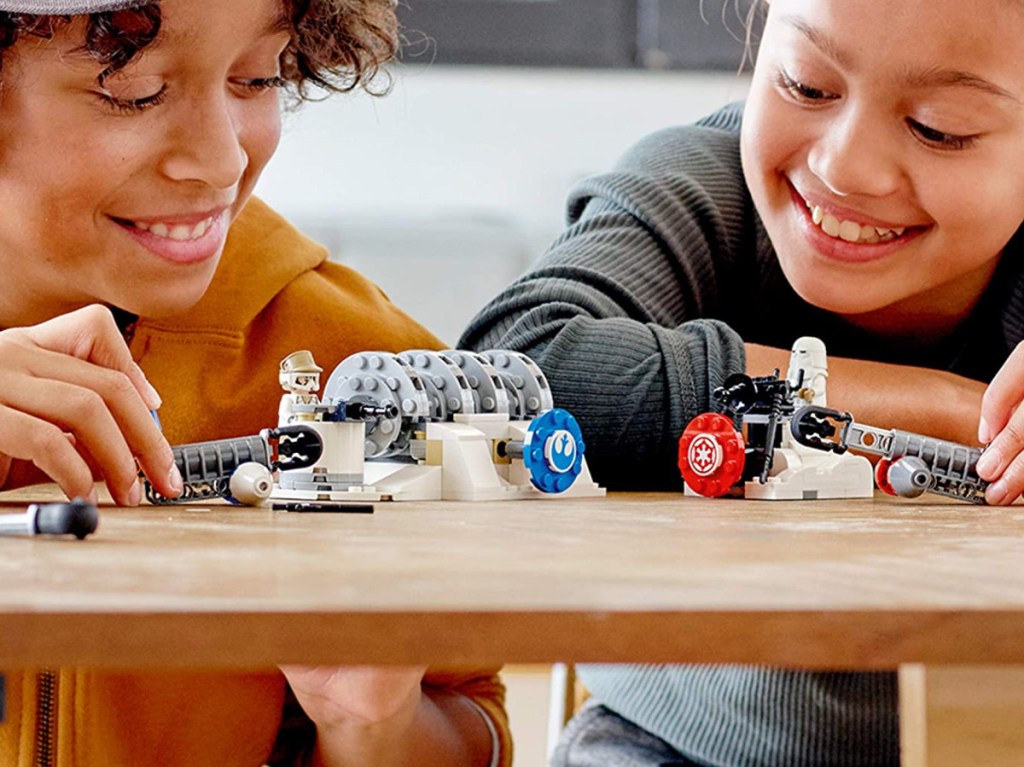 two kids playing with Star Wars LEGO toy kit