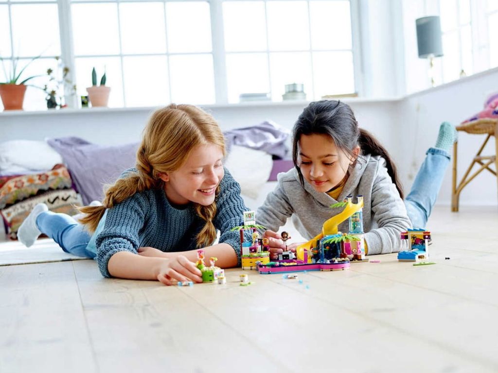 two girls playing with lego pool seton floor