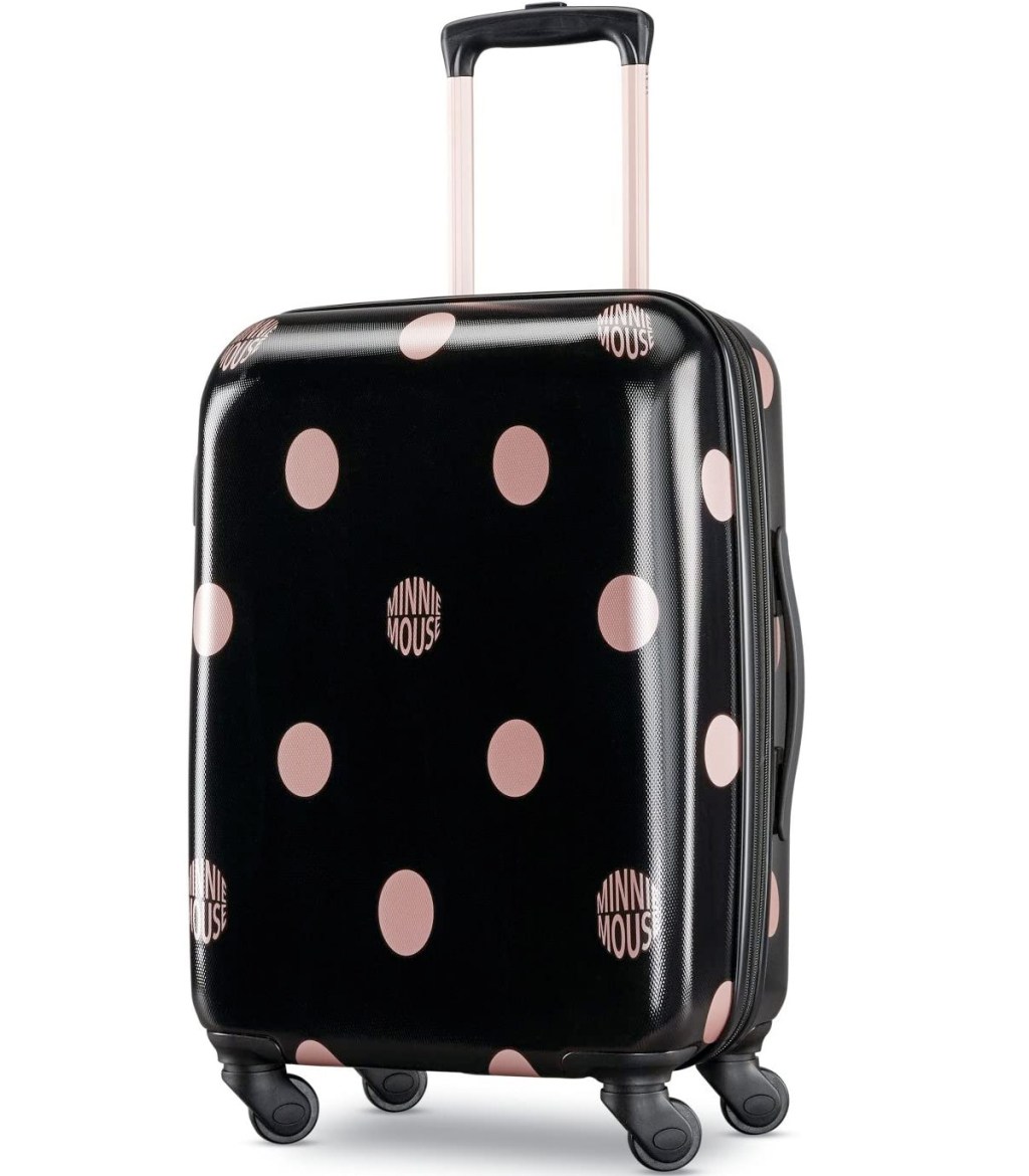 black hardside luggage with rose gold polka dots