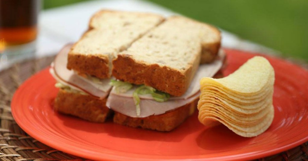 sandwich cut in half next to Pringles chips