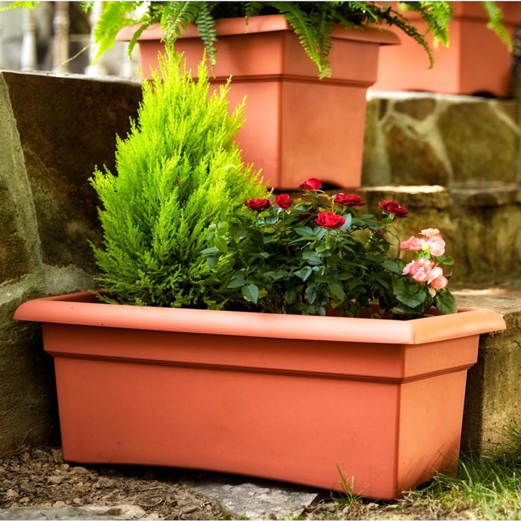 Terra Cotta Veranda Plastic Window Deck Box Planter next to steps with plants inside of it