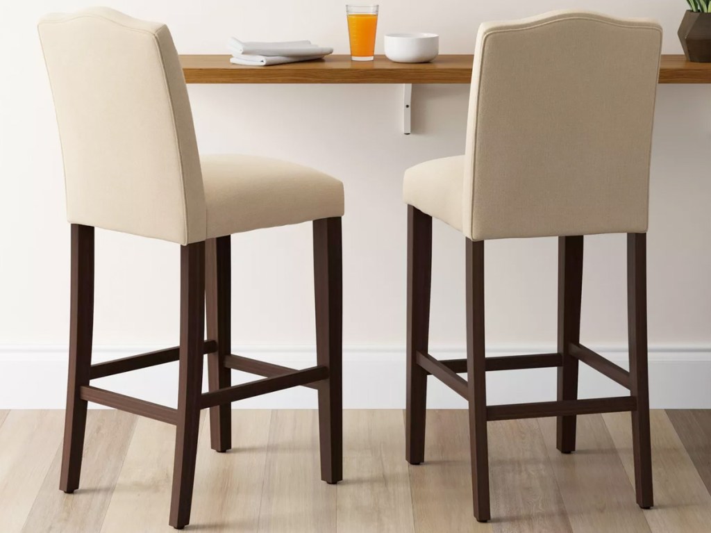 two white barstools with wooden legs at breakfast bar