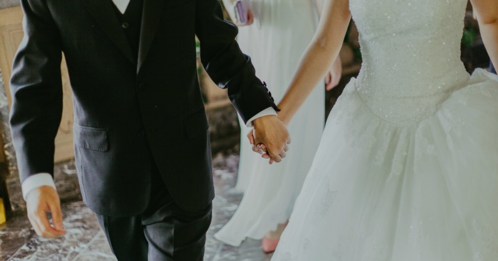 Wedding couple holding hands