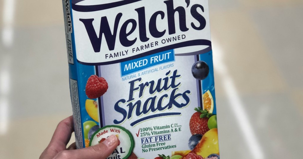 hand holding box of fruit snacks