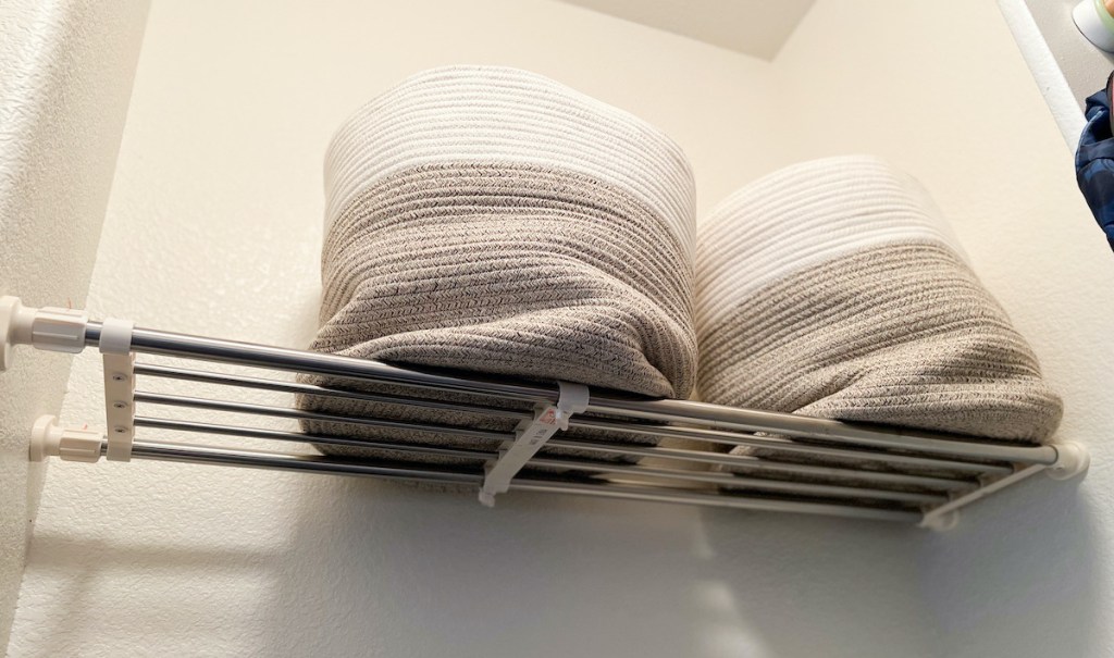 adjustable shelf in closet with two canvas baskets