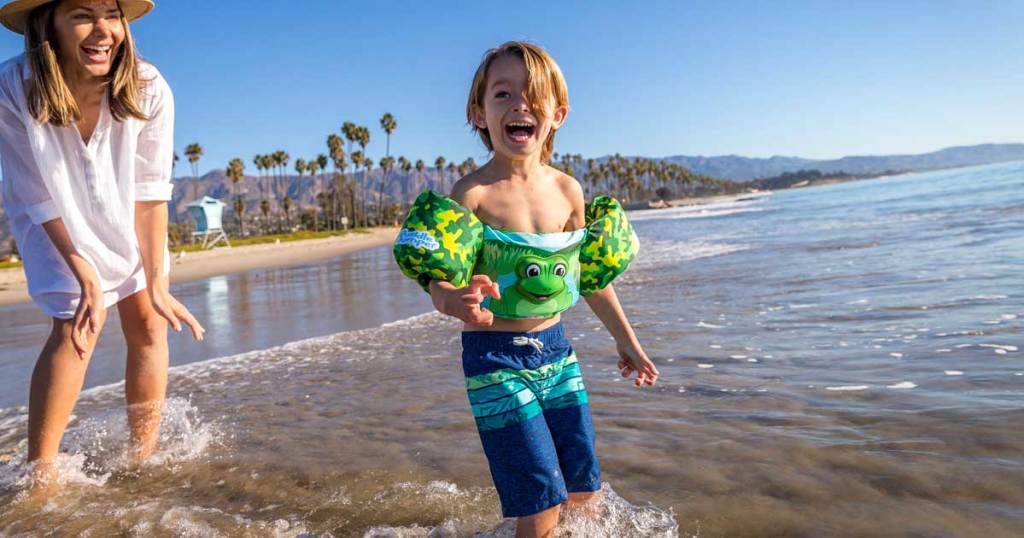 boy-in-frog-floatings-on-ocean 