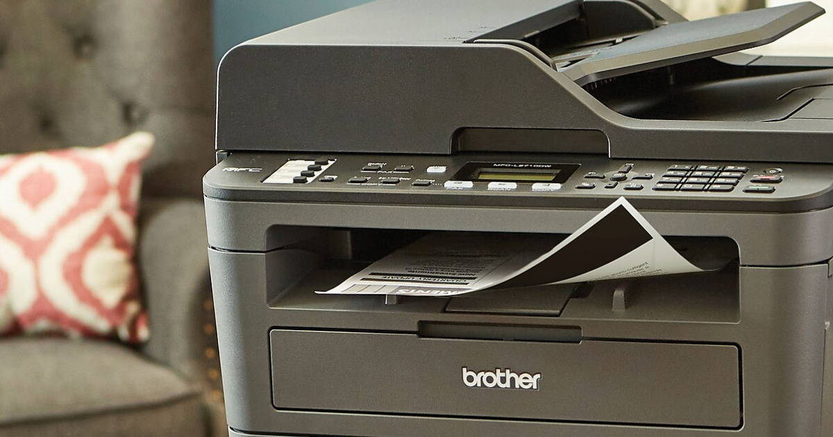 Brother laser printer with gray chair and pillow in background