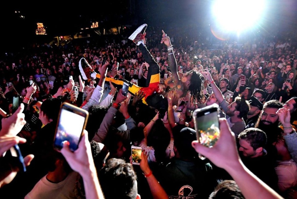 man crowd surfing at concert