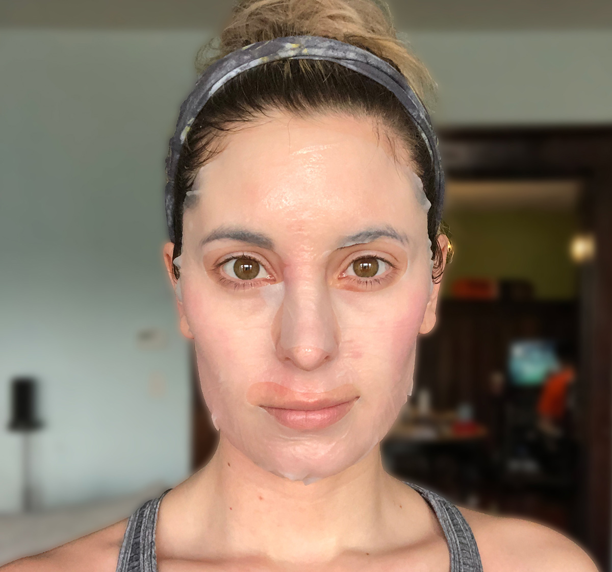 woman wearing rael sheet mask