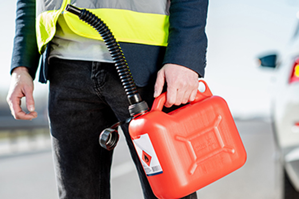 person holding a gas can