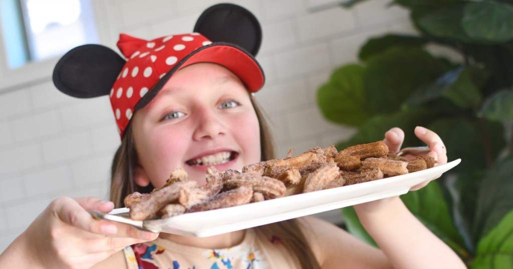 girl holding tray of homemade disney churros