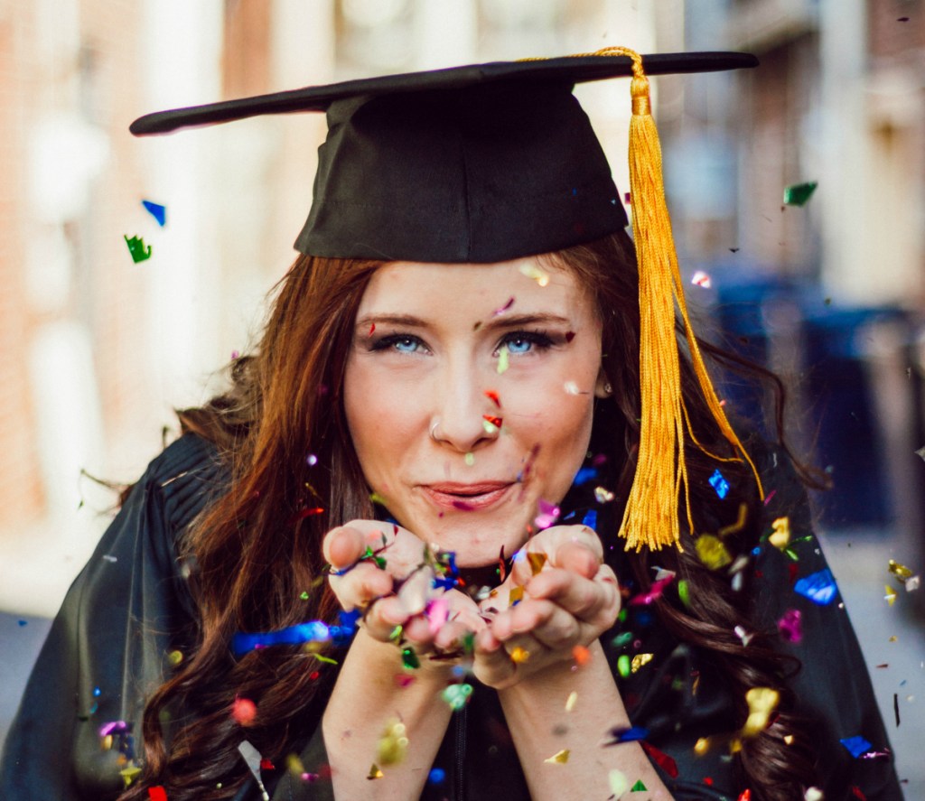 girl blowing confetti