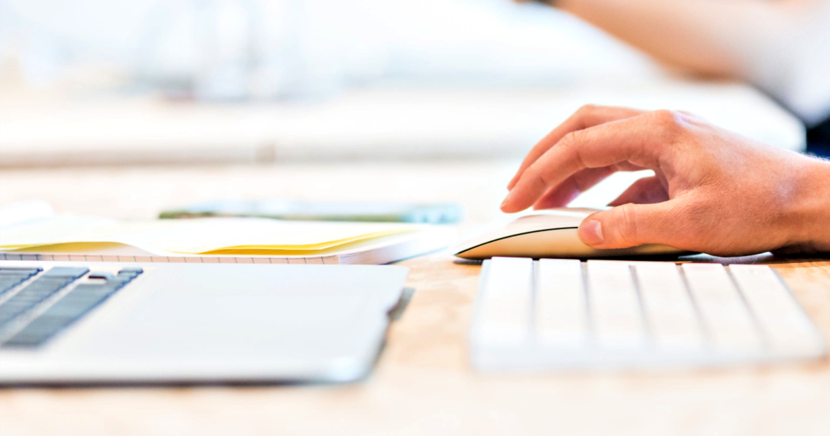 laptop with person holding mouse