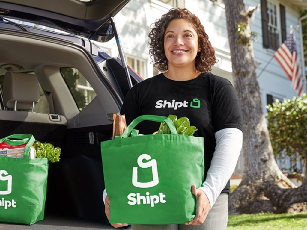 woman carrying Shipt shopping bag