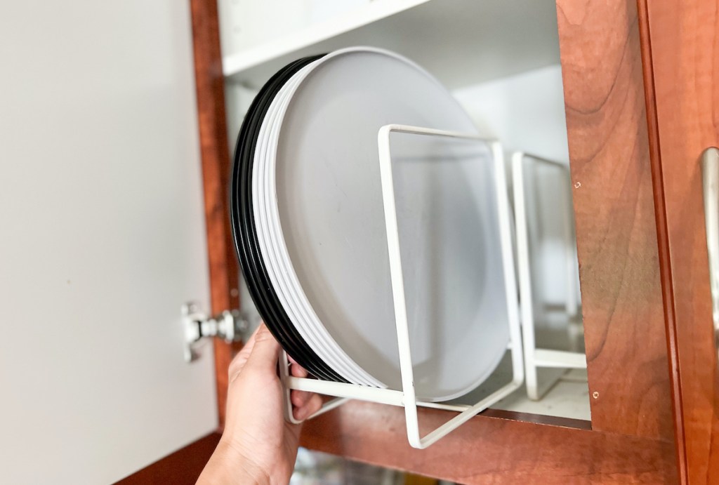 hand holding rack with plates on it