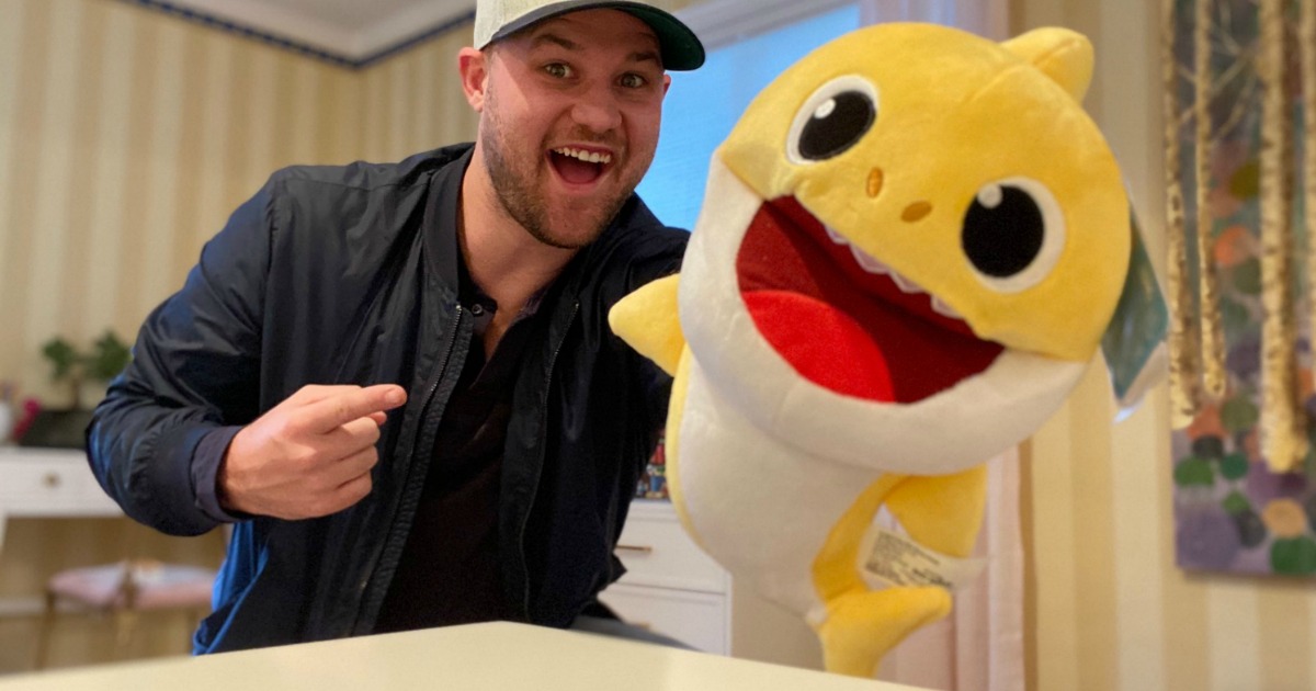 man holding a yellow baby shark puppet