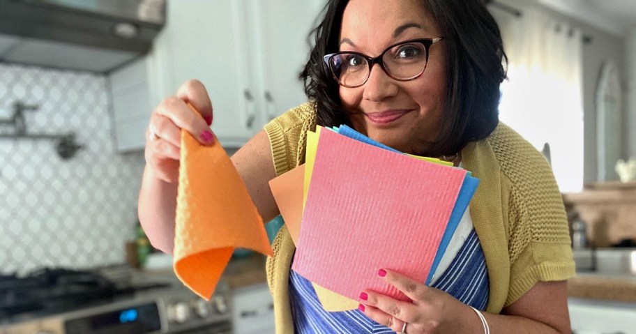 woman holding Swedish dish cloths from amazon