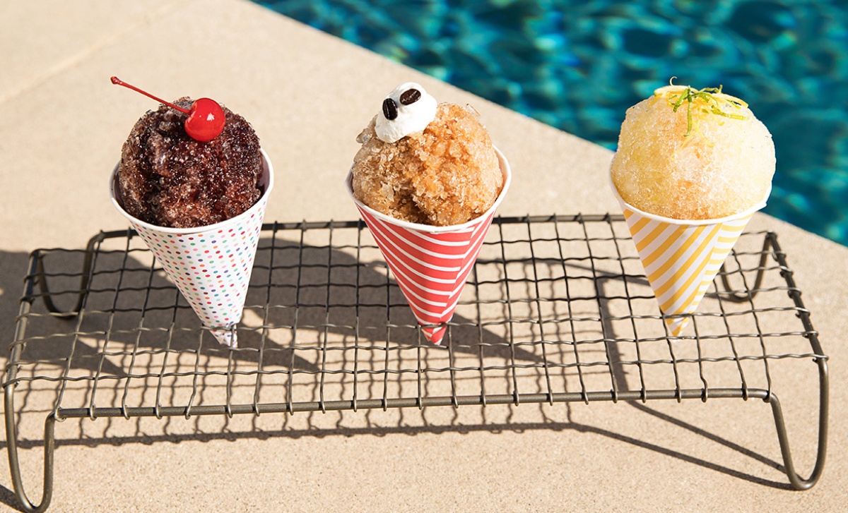 3 snow cones sitting in a rack