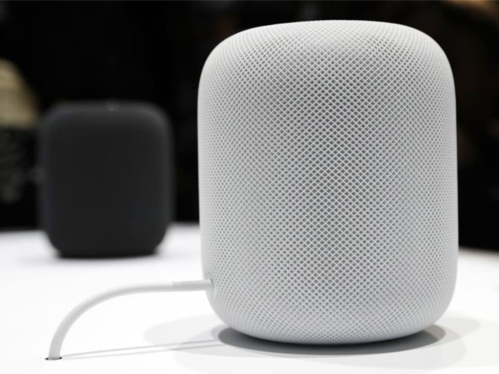 white apple homepod with black apple homepod in the background