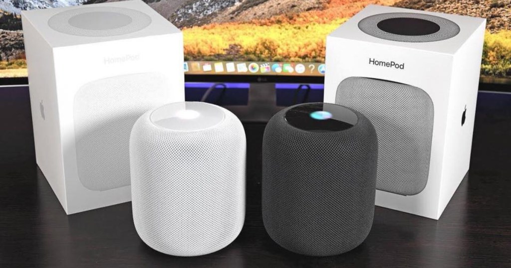 two white and space apple homepods out of the box with the boxes in the background