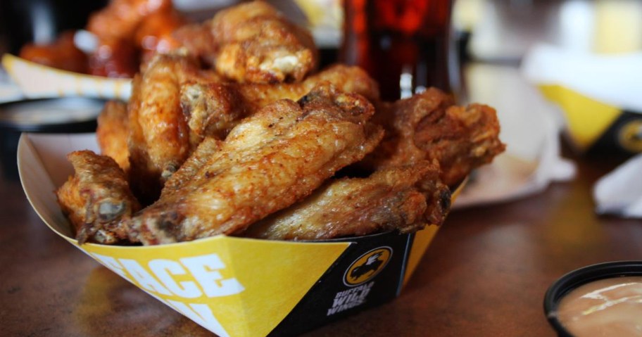 basket of buffalo wild wings traditional wings with beverage in the background