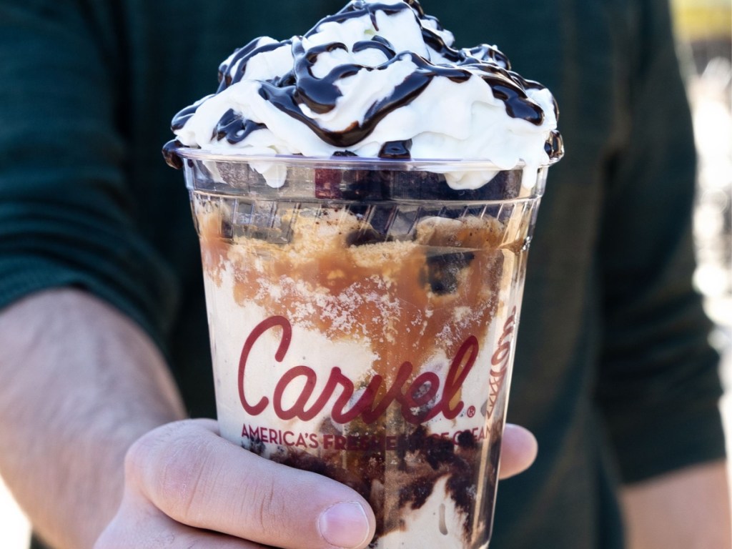 man holding a large carvel chocolate and caramel sundae