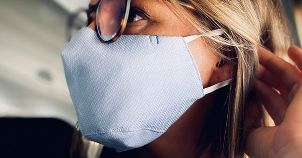 Woman wearing face mask in airplane