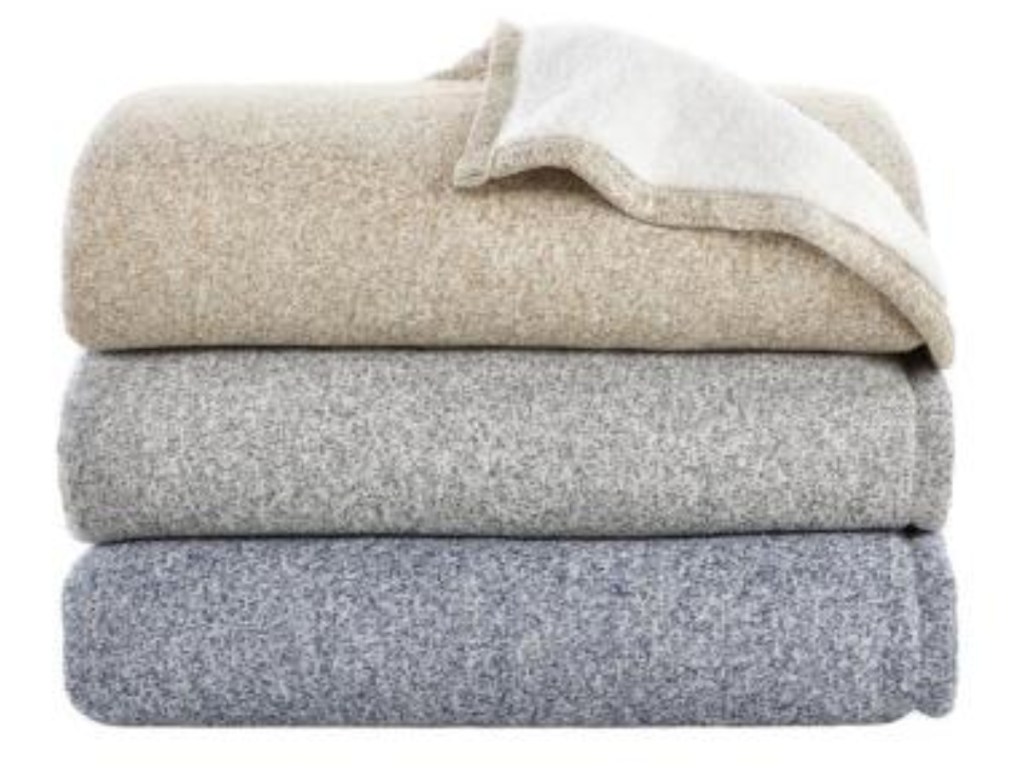 three folded StyleWell Oversized Sweater Knit Sherpa Blanket in midnight, khaki, and charcoal gray