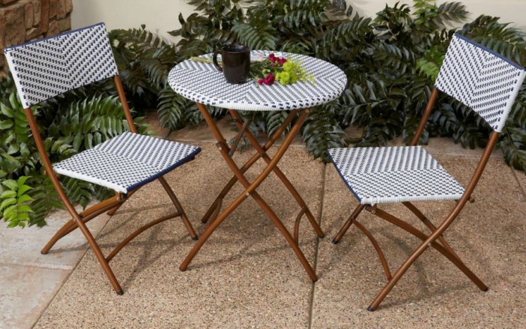 hampton bay patio table in front of greenery