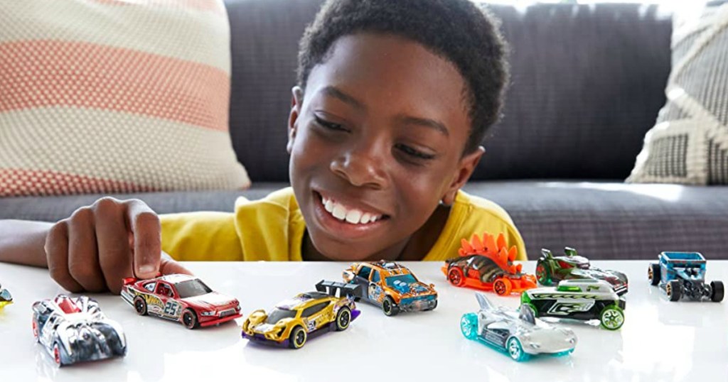 boy playing with Hot Wheels cars