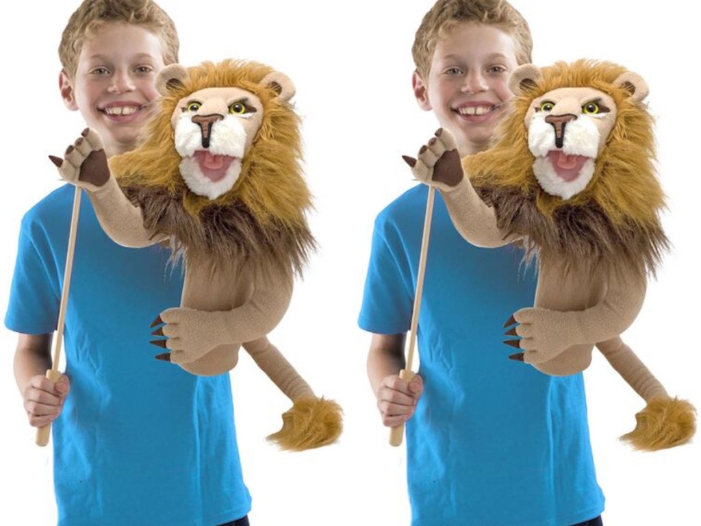 boy holding Melissa & Doug Rory the Lion Puppet 