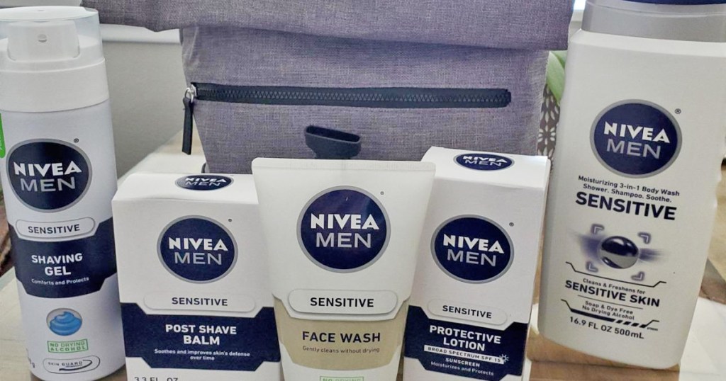 white and blue bottles of nivea men's personal care products and grey travel bag behind them