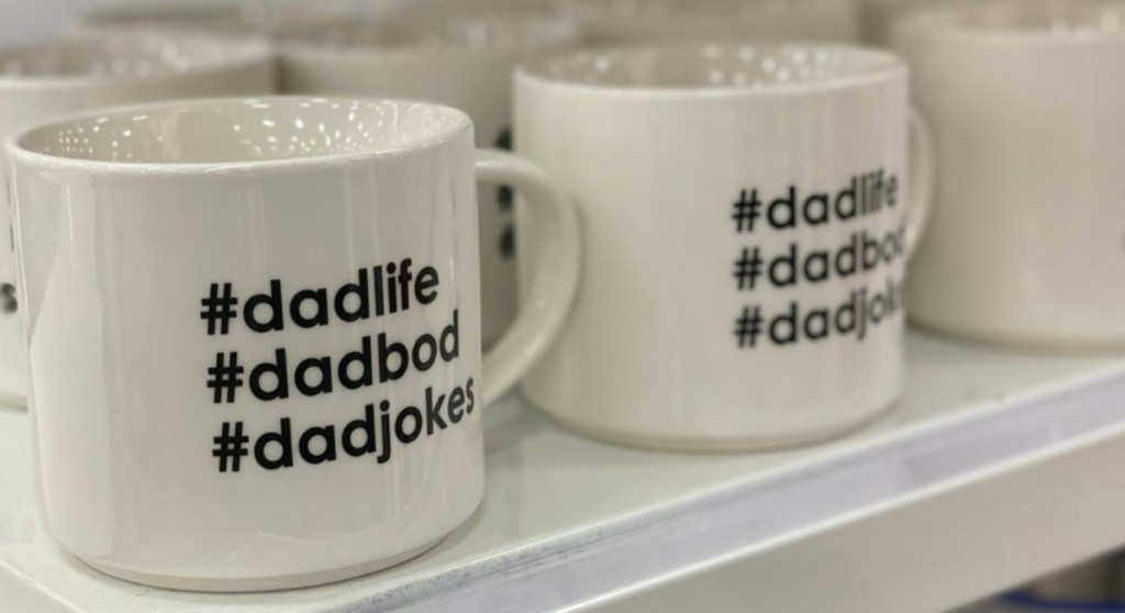 white Father's Day theme mugs on store shelf