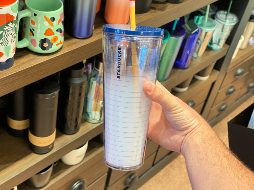 man hand holding Starbucks Teacher Notebook Tumbler in store