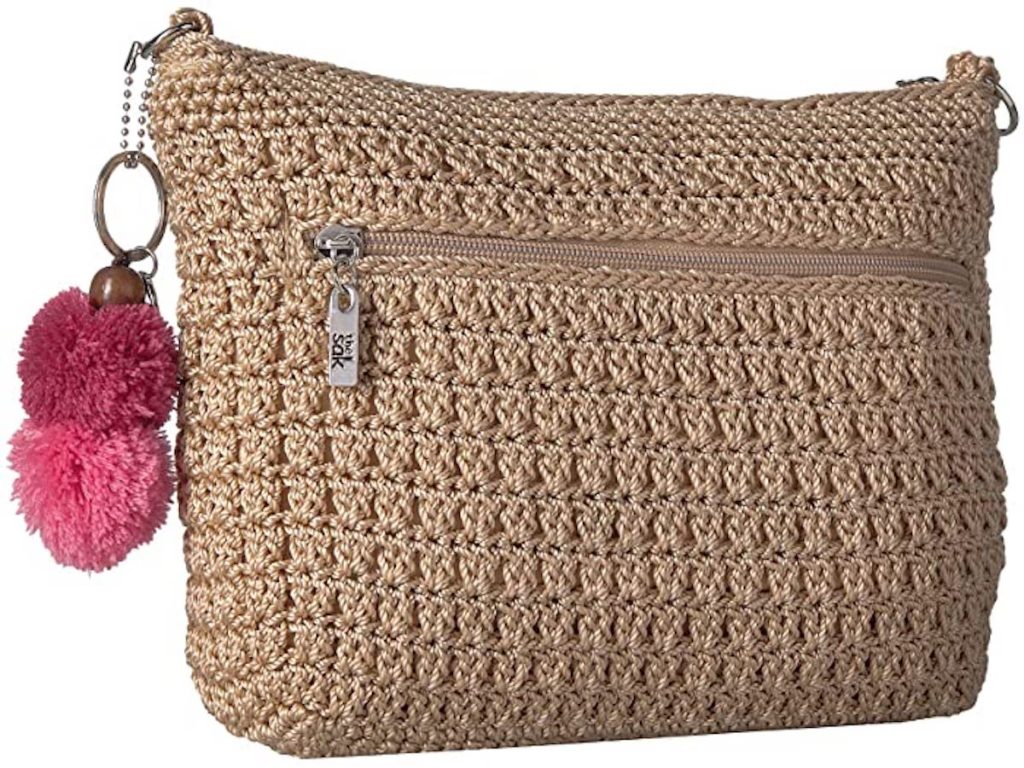 tan colored the sak Greenwood 3-in-1 Demi Crossbody Bag with pink pom poms