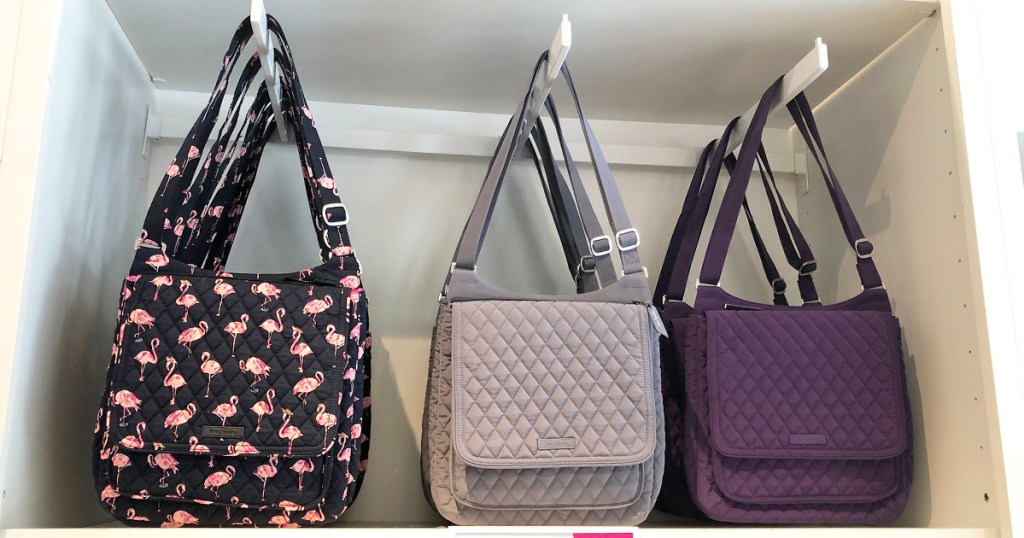 three quilted crossbody bags hanging on display in store