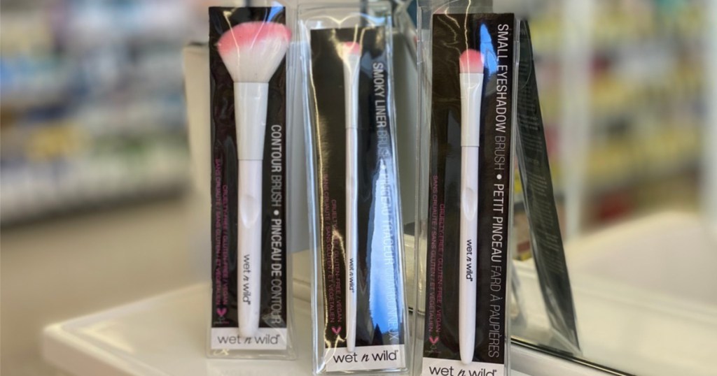 three white and pink makeup brushes in packaging in store